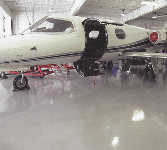 Polyaspartic floor coating in hangar - Sparta-Flex